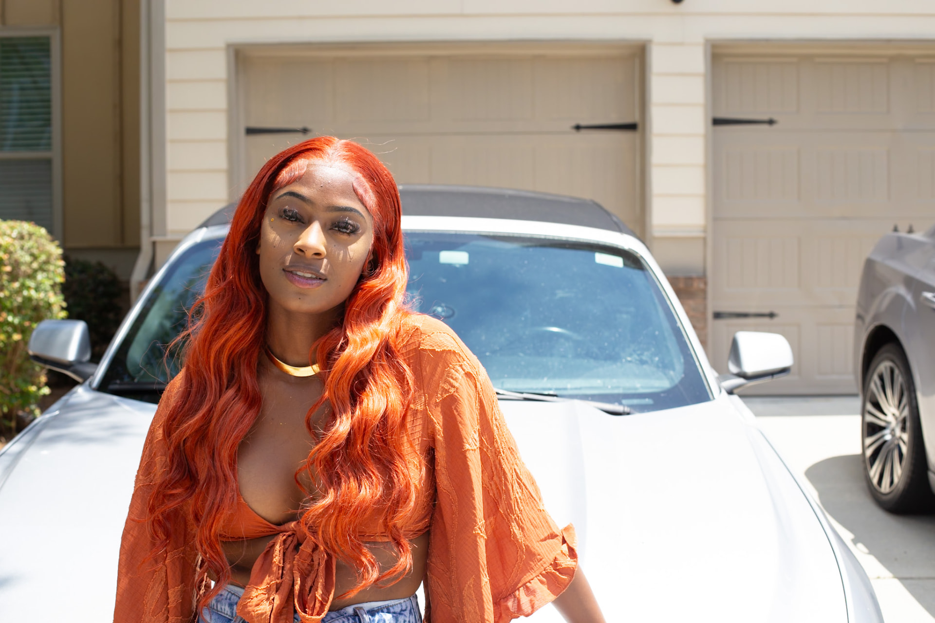 Model editorial — copper waves and rust crop top on the block