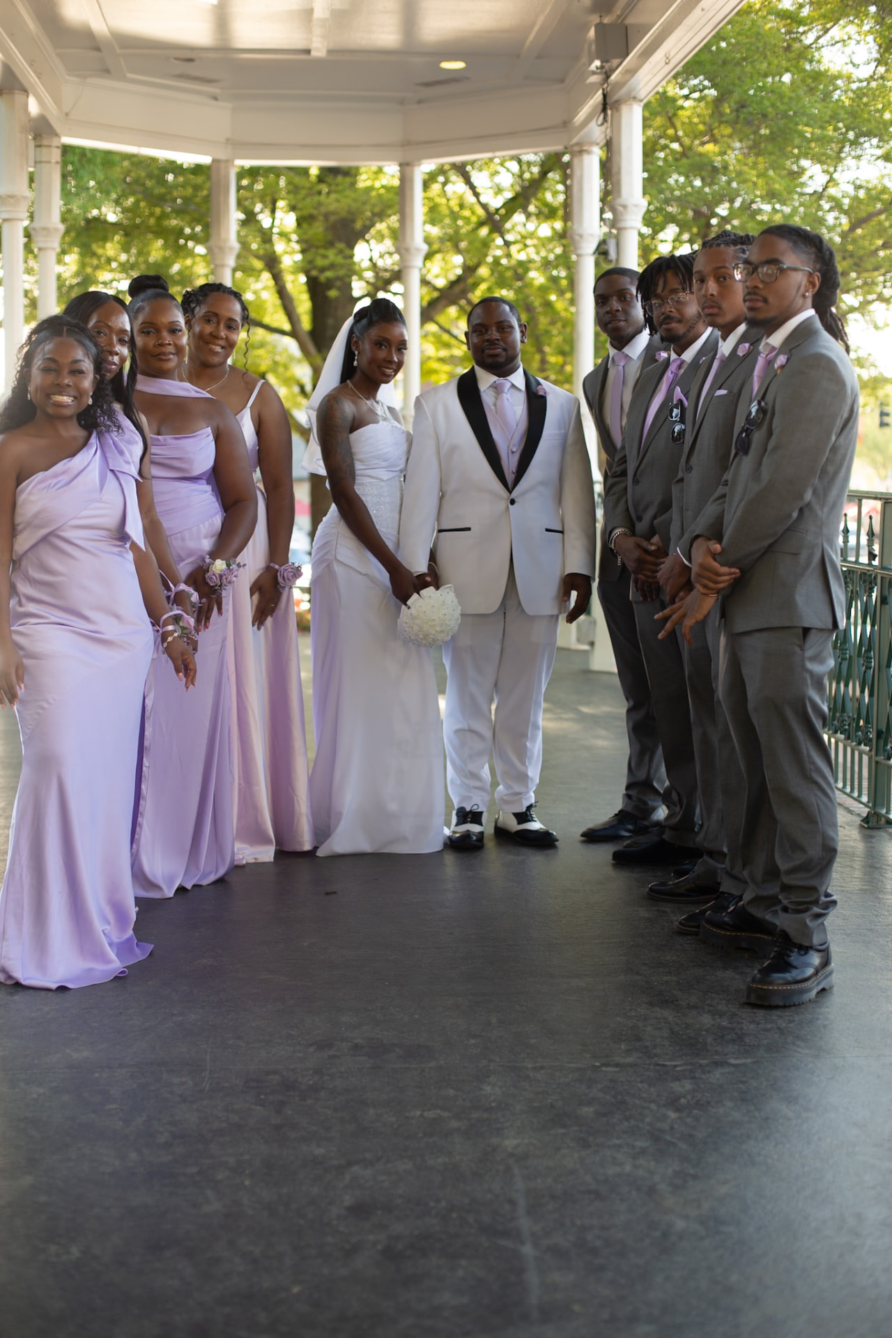 Wedding — the full wedding party lined up under the gazebo, lilac and grey