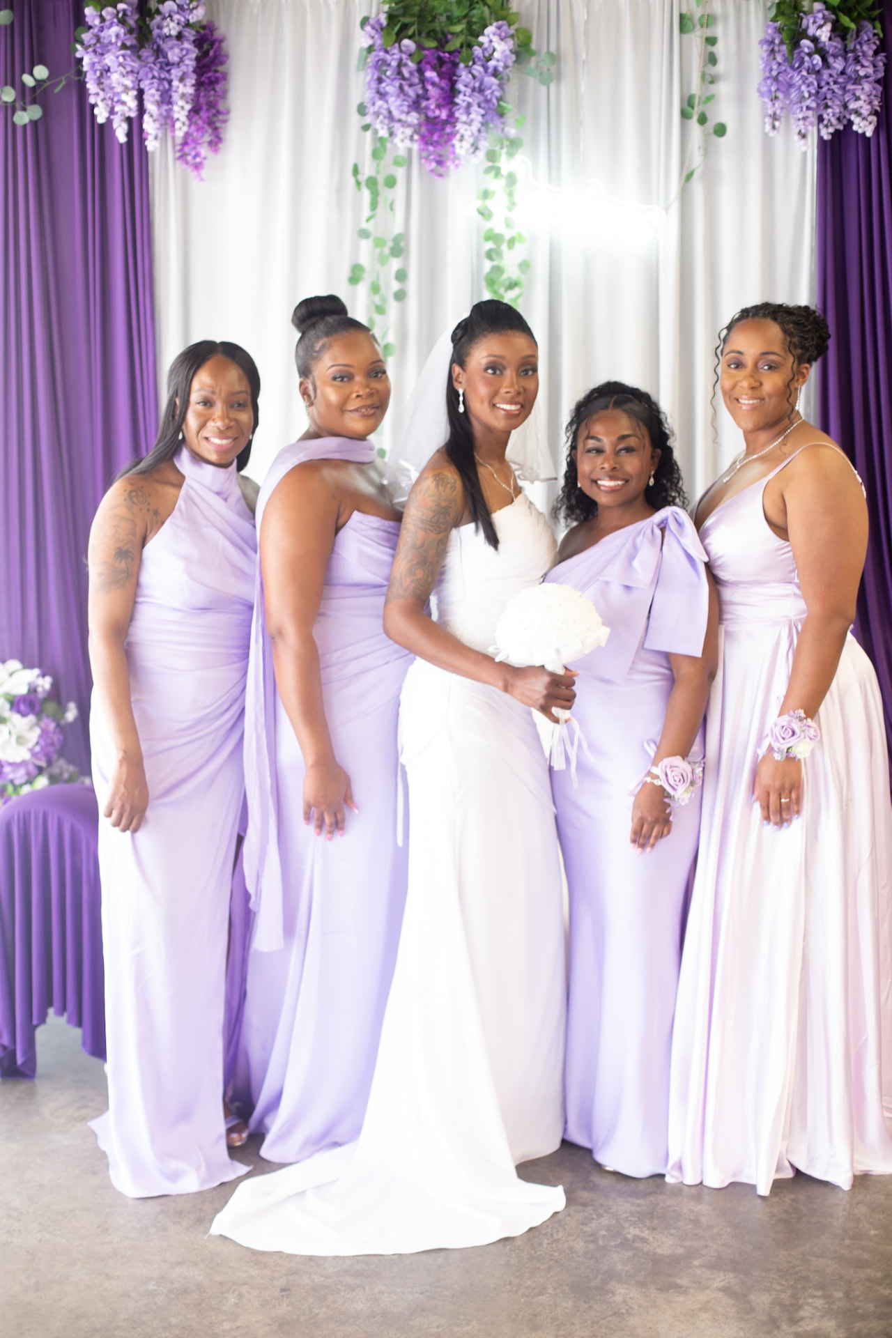 Wedding — bride with her bridesmaids in lilac gowns