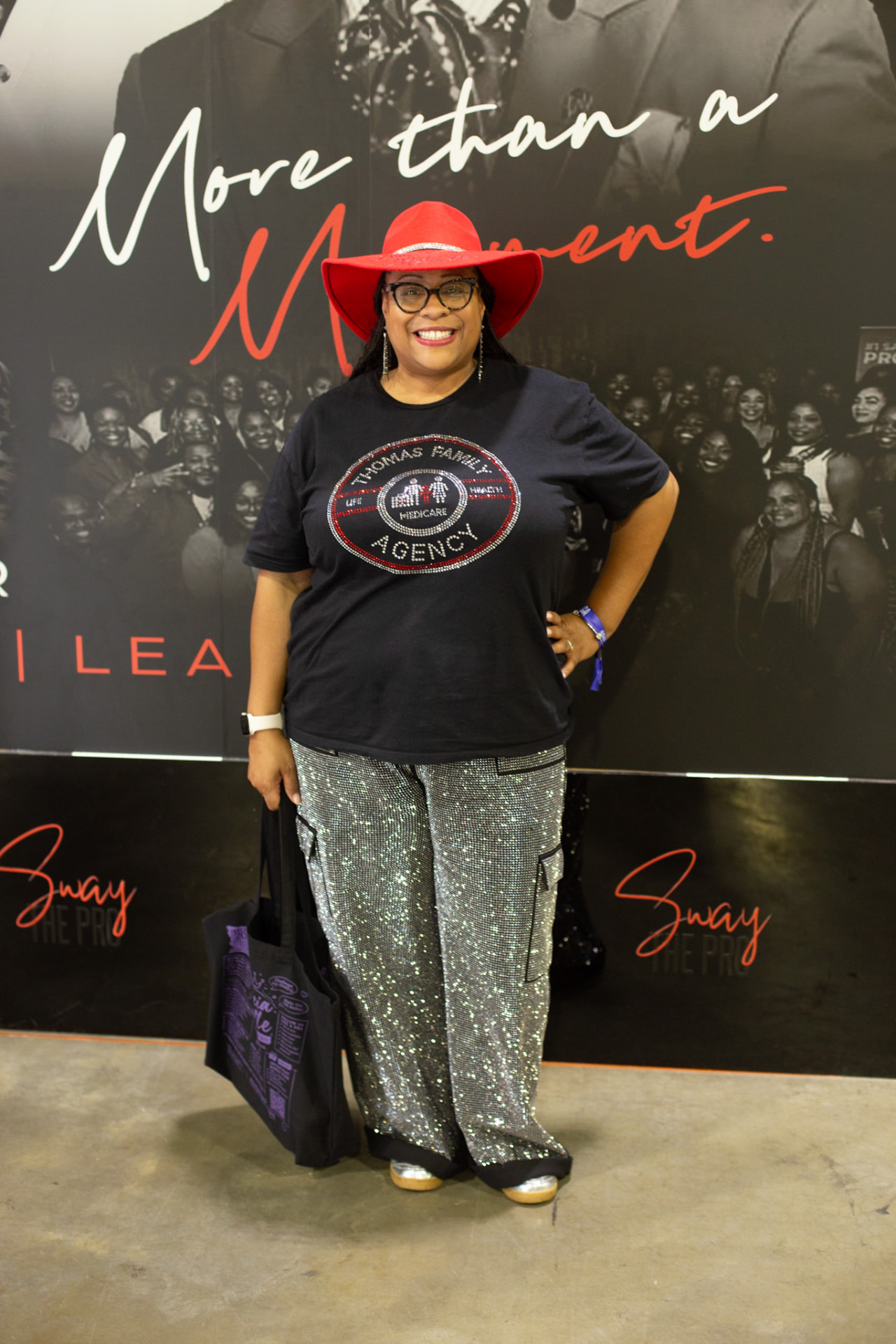 Invest Fest — guest in a red hat on the More Than a Moment red carpet