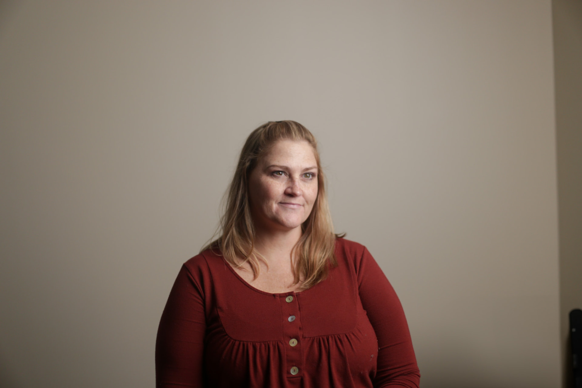 Portrait — soft-lit studio portrait in a rust top