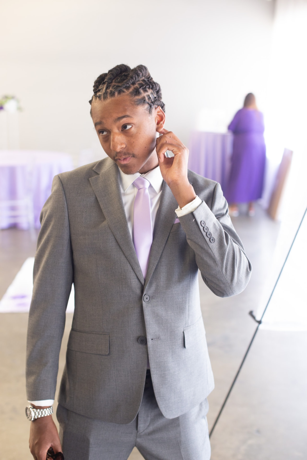 Wedding — groom in a grey suit and lilac tie, getting ready before the ceremony