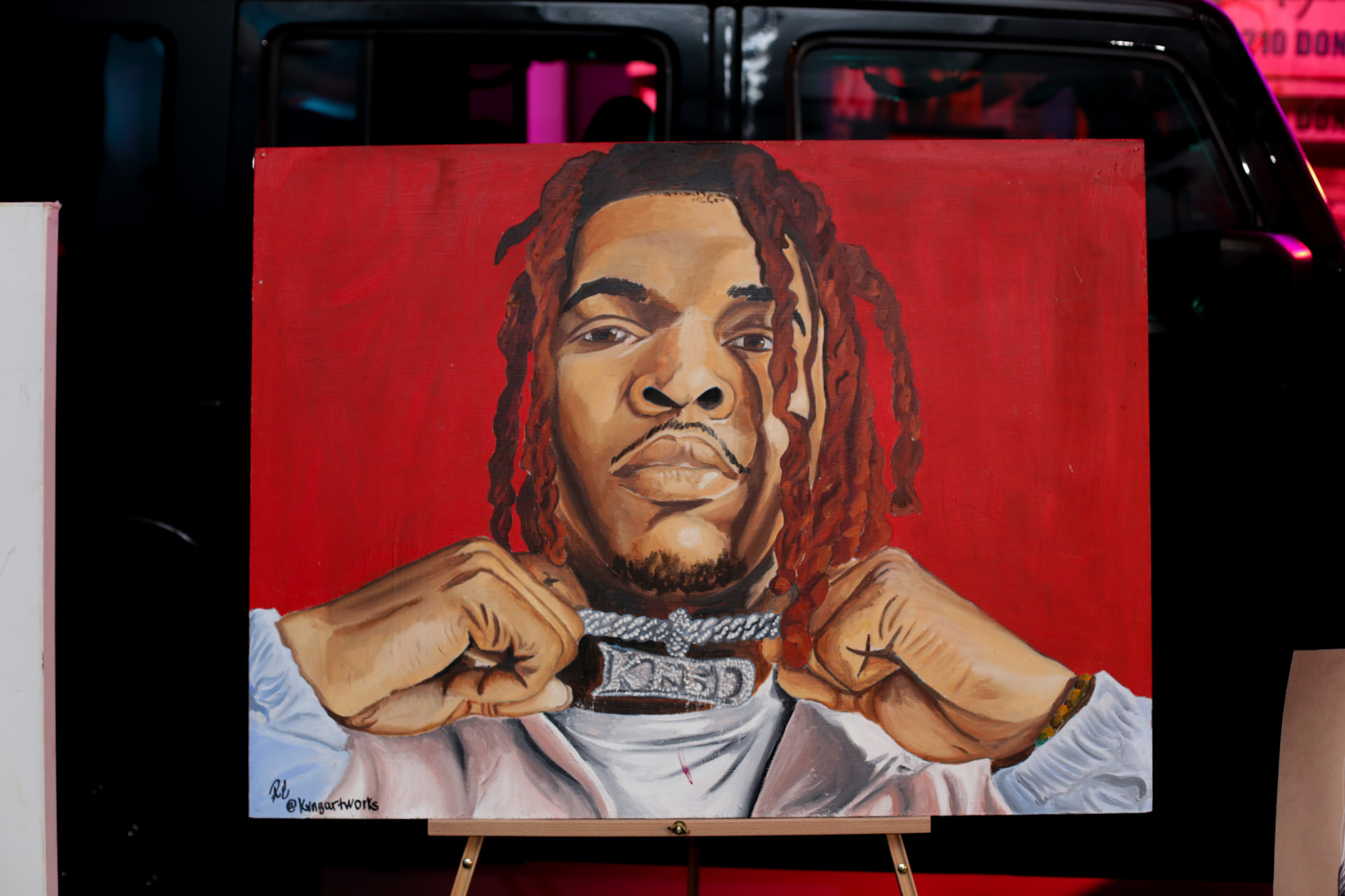 Live art at the event — portrait painting on a red canvas