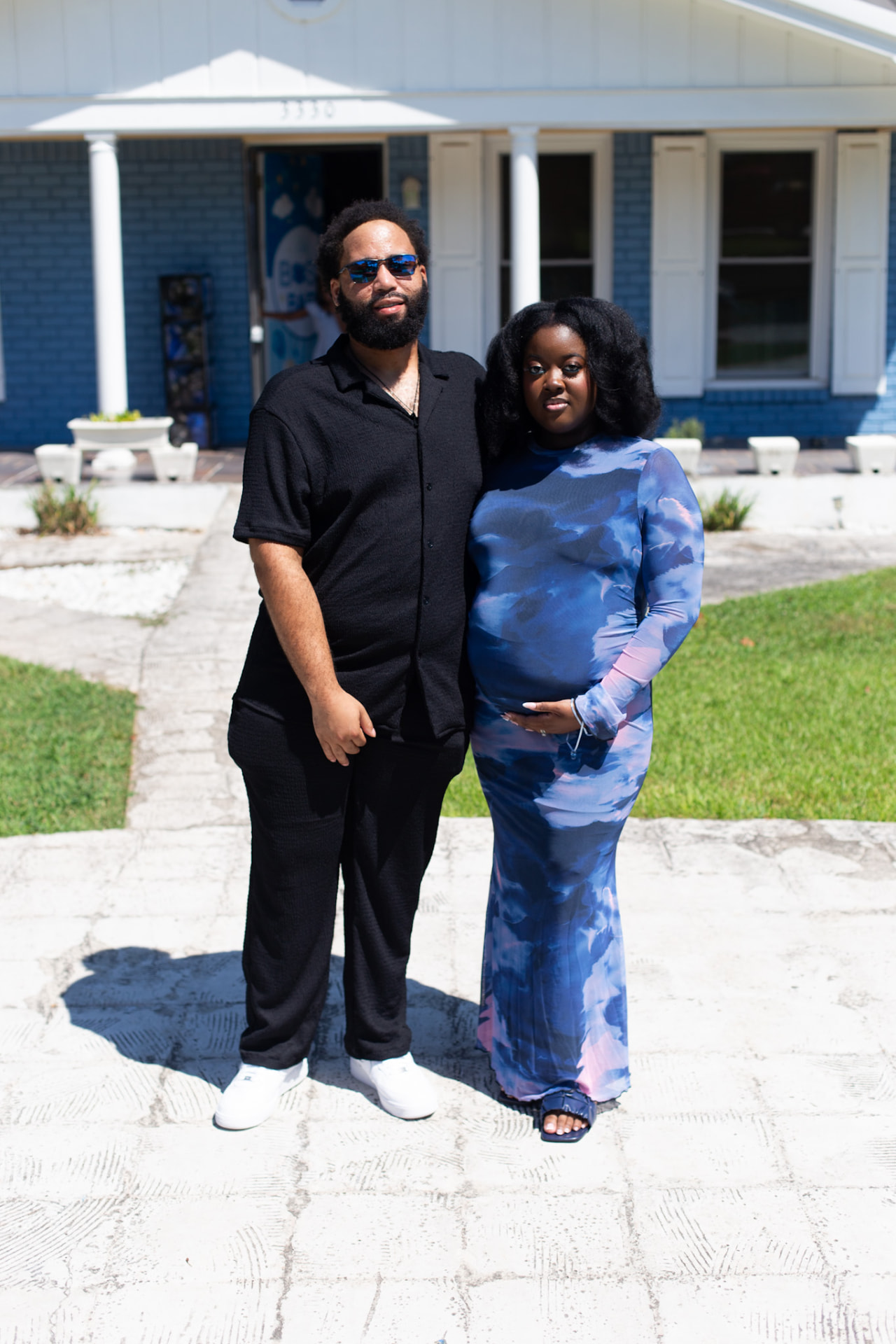 Maternity event session — expecting couple outside in the sun