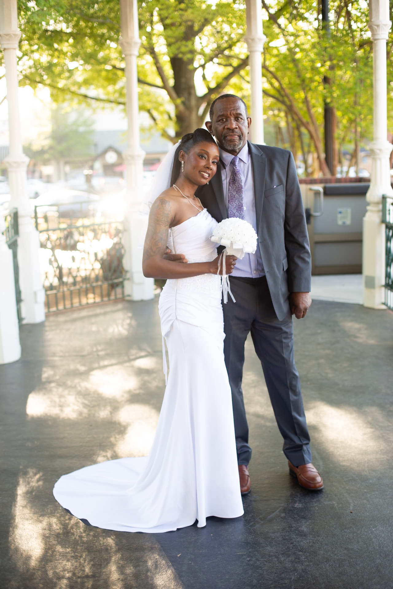 Wedding — bride and her father in the golden hour gazebo light