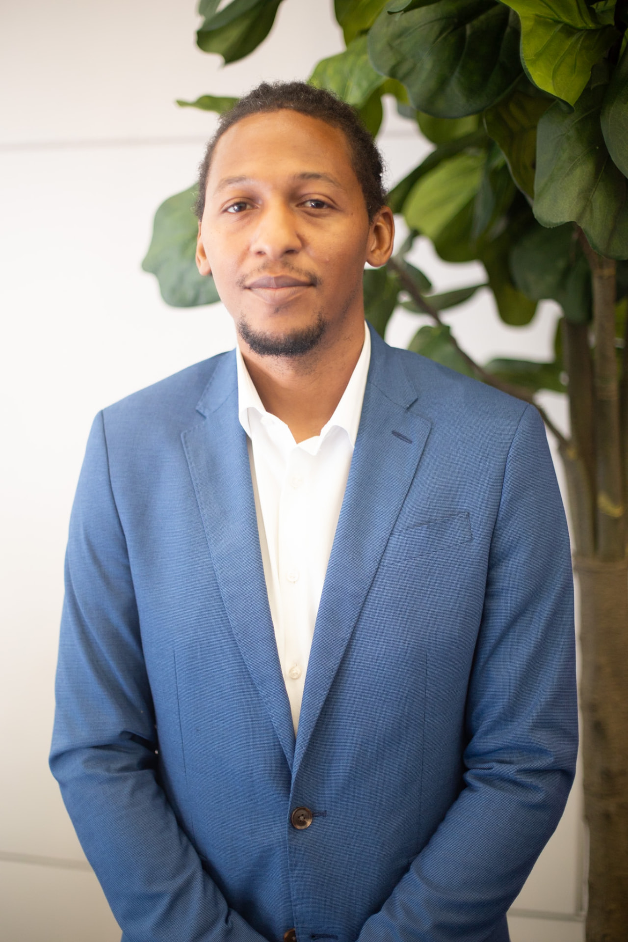 Portrait — blue suit and white shirt, calm and confident