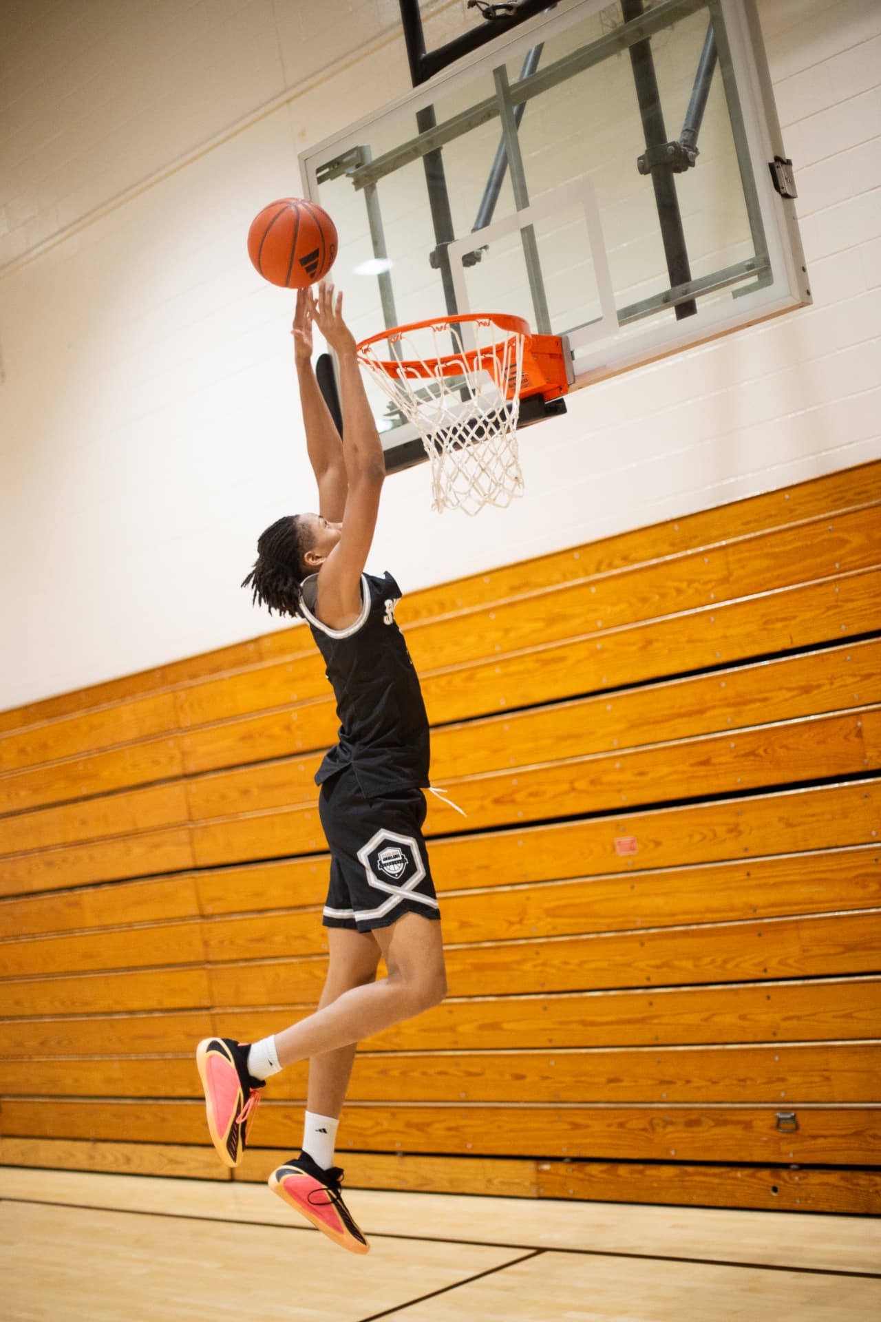 Sports action — rising for the one-hand dunk in the Shiloh black kit