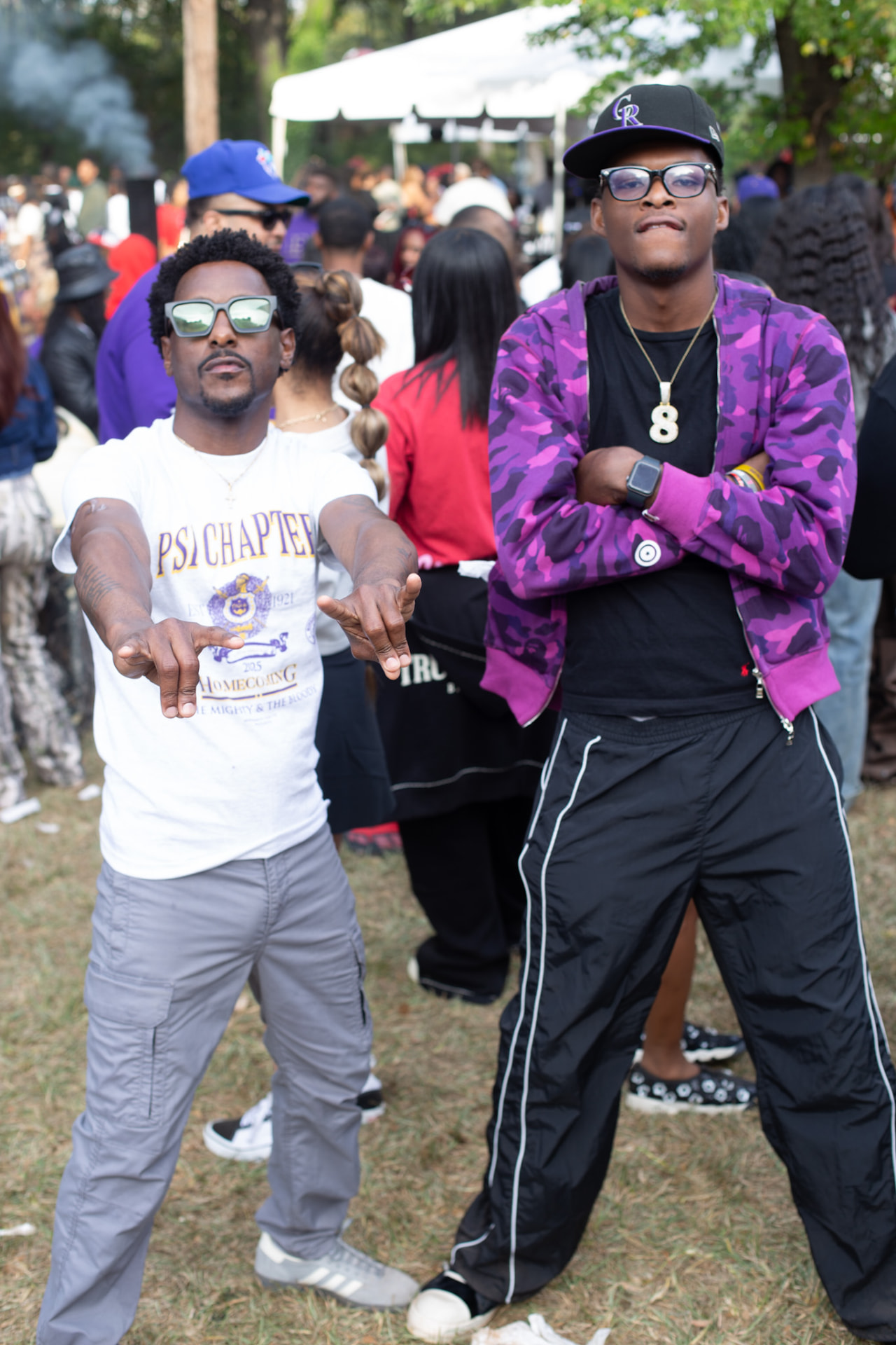 Event photography — two festival-goers posing on the lawn